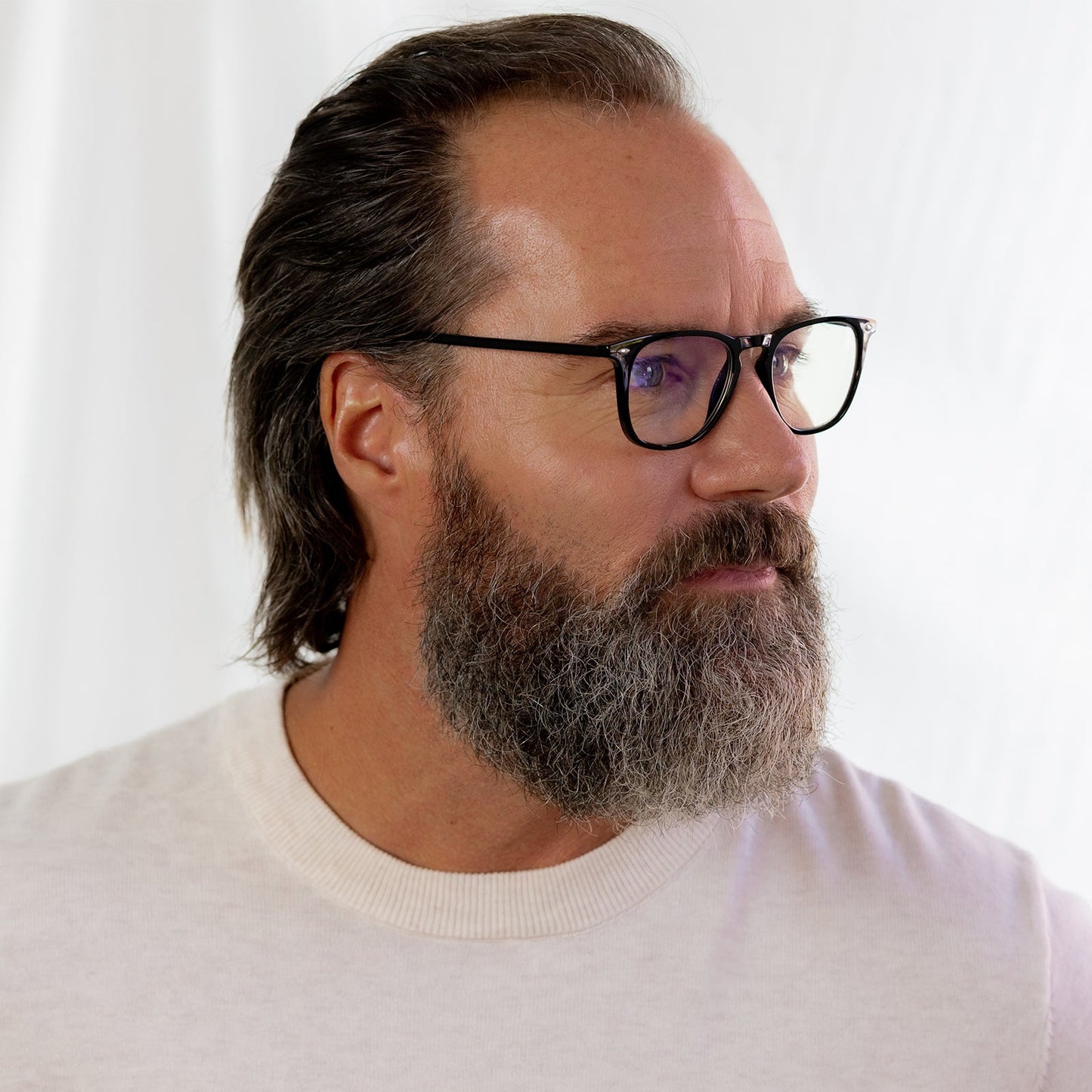 male wearing the griffin in black and blue light readers