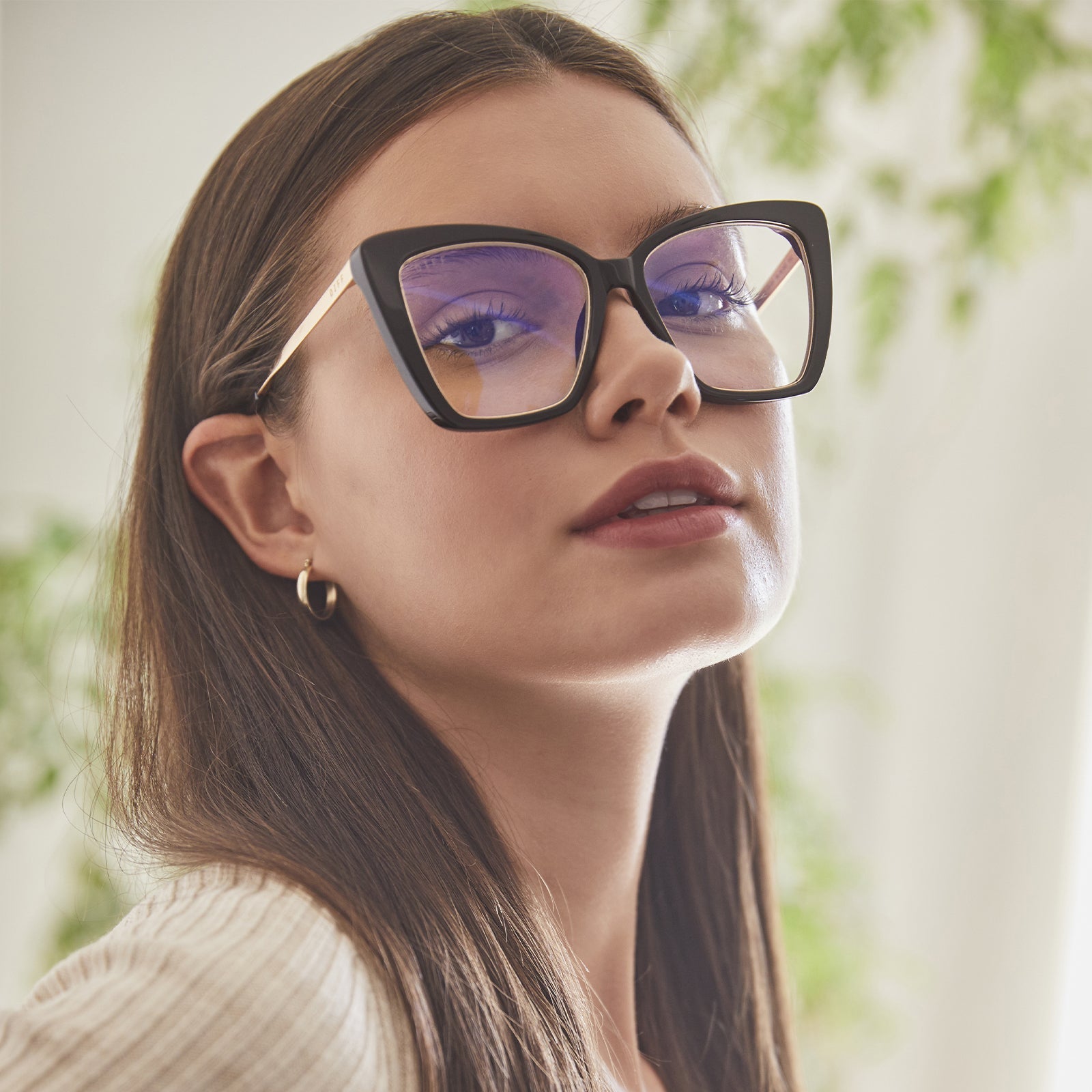 lifestyle - brunette model wearing becky iv black with blue light tech 