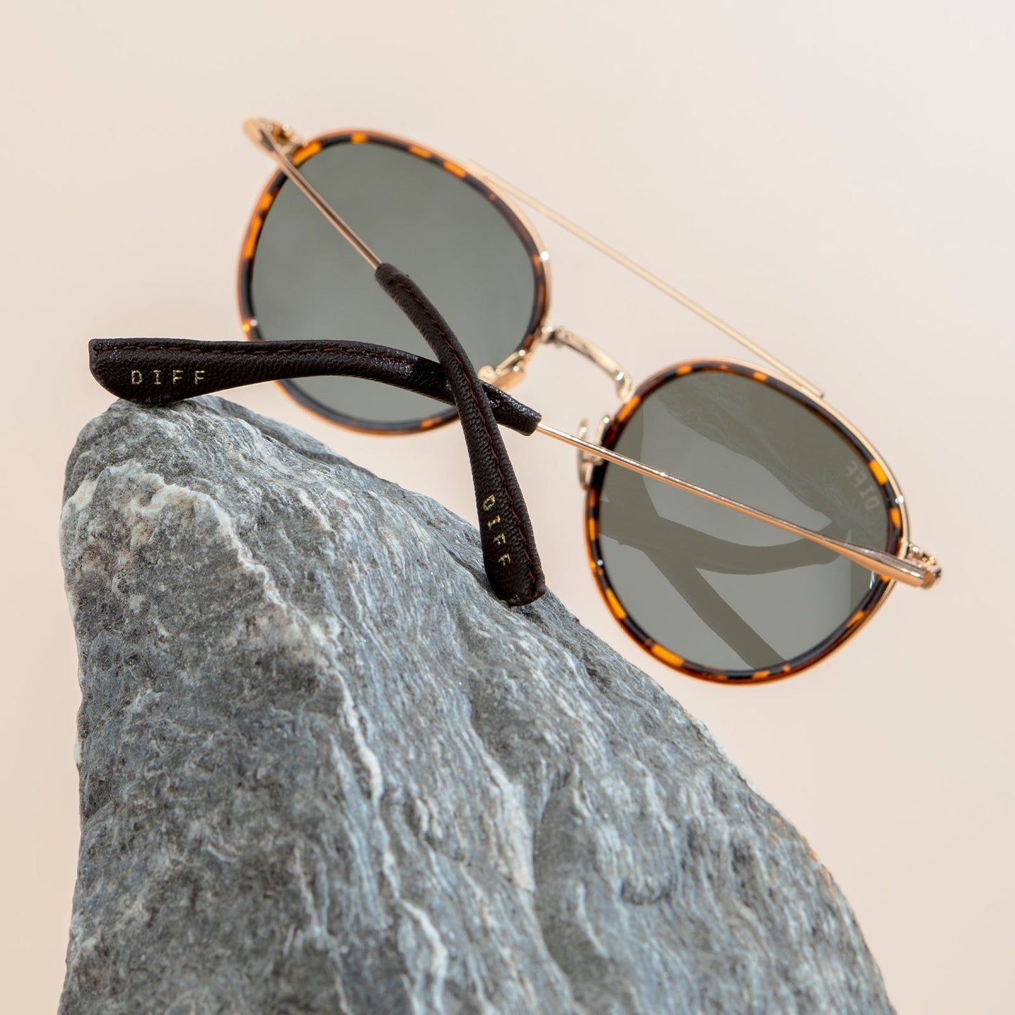 BOBA FETT SUNGLASSES PROPPED UP ON TWO ROCKS