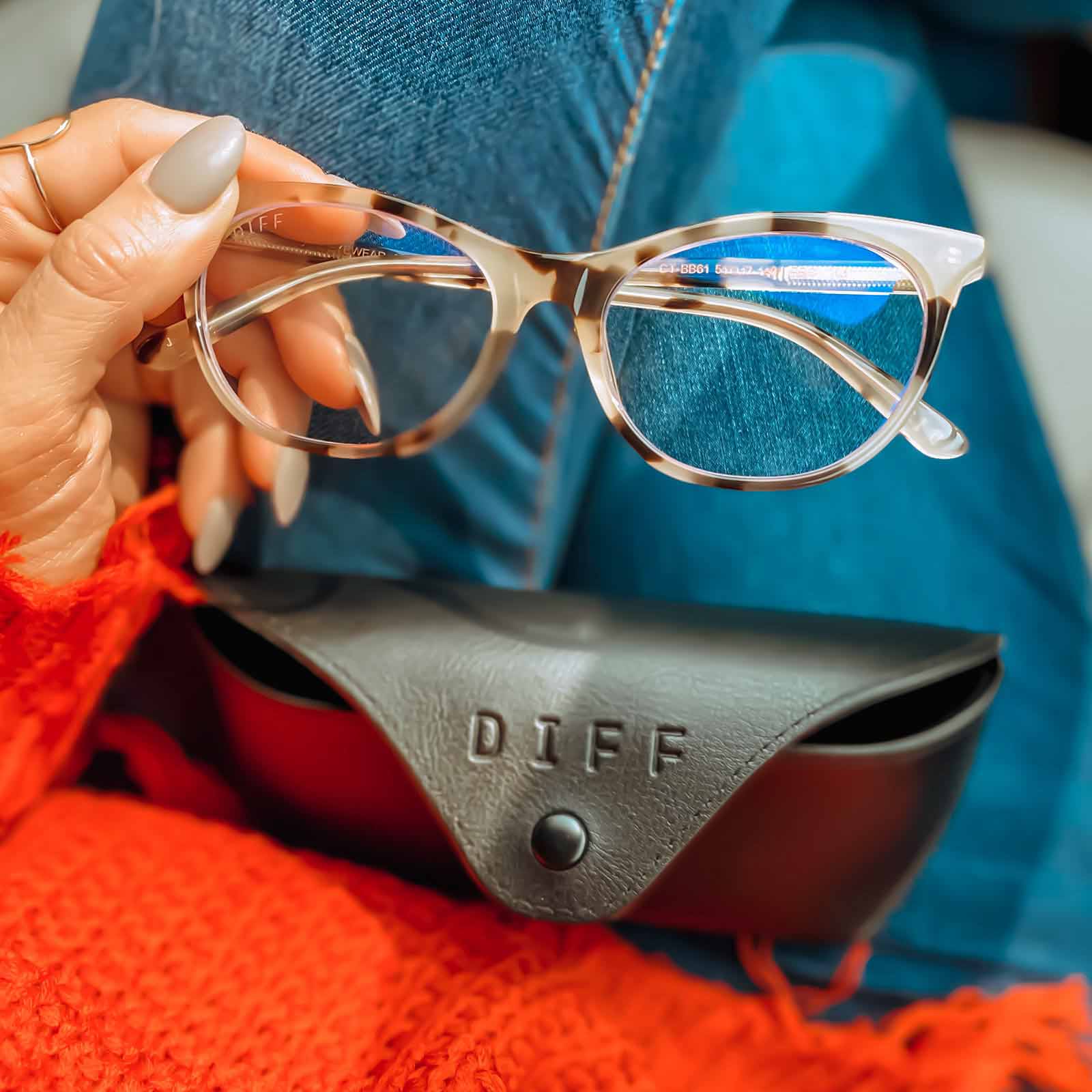 influencer holding the jade in cream tortoise and blue light