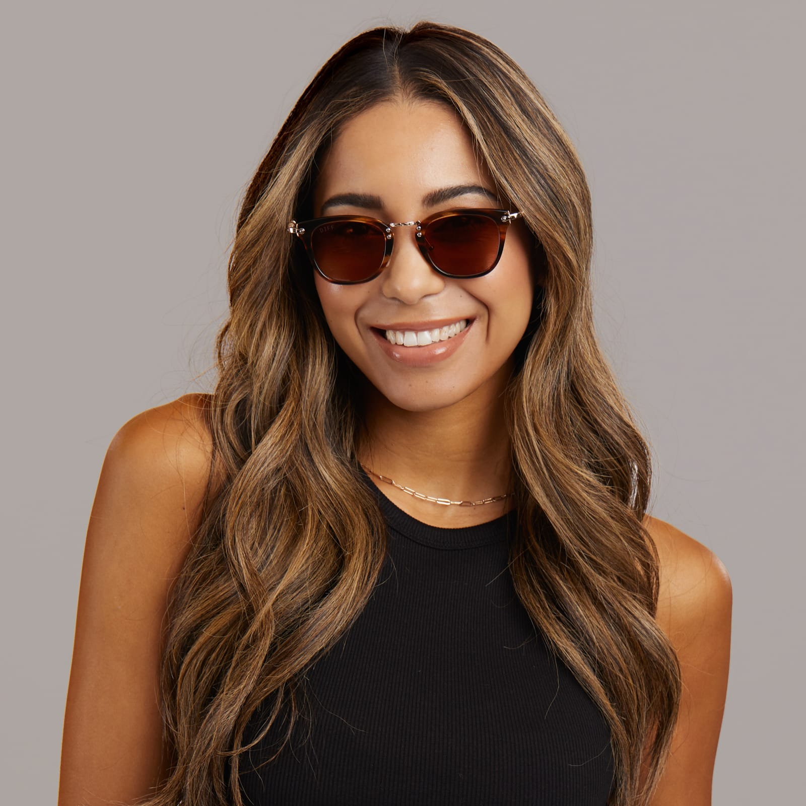 on female model - diff eyewear x harry potter Gryffindor square sunglasses with a lions mane gold frame and brown gradient lens