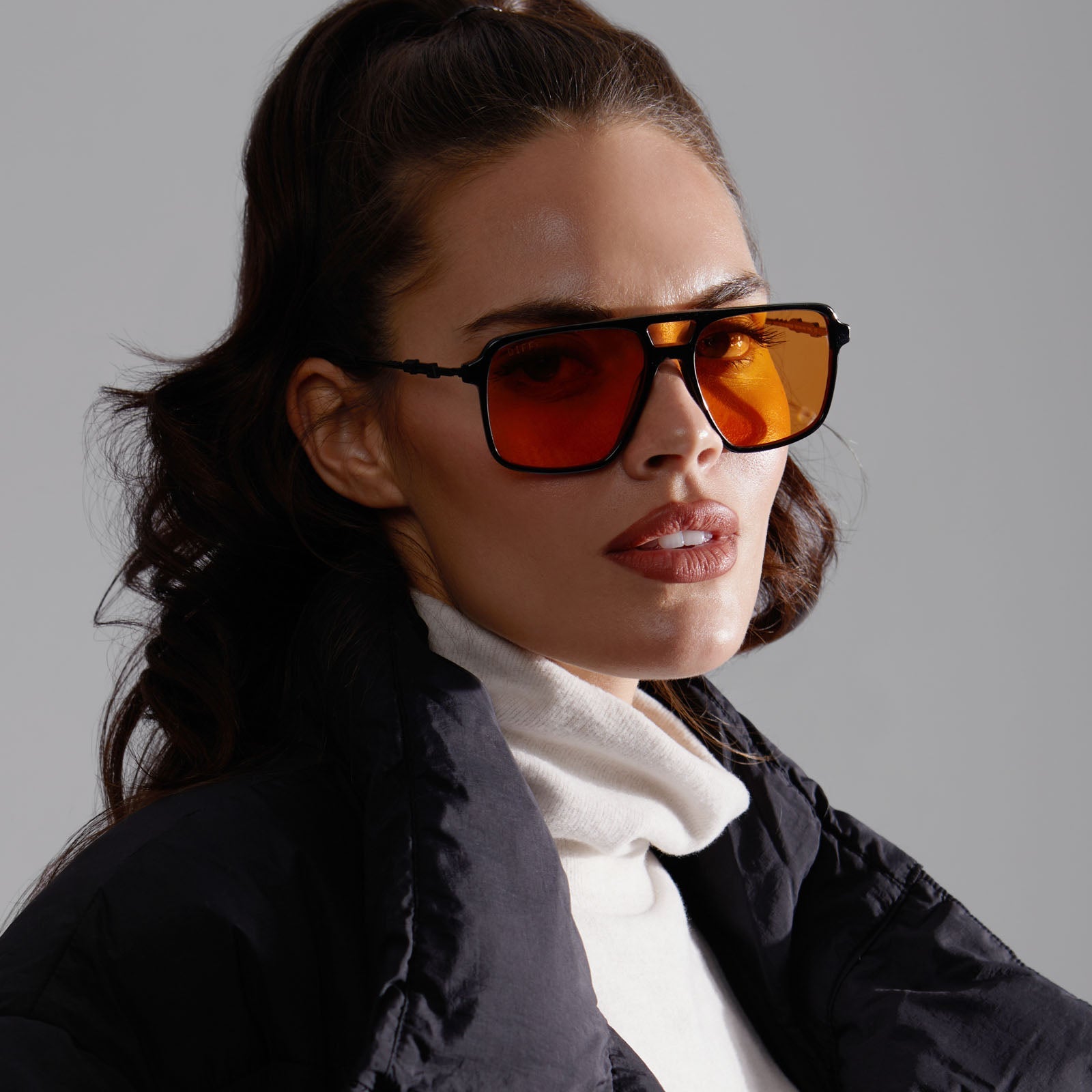 lifestyle - female model looking at the camera wearing star wars x diff eyewear fennec shand sunglasses with a black frame and orange lenses