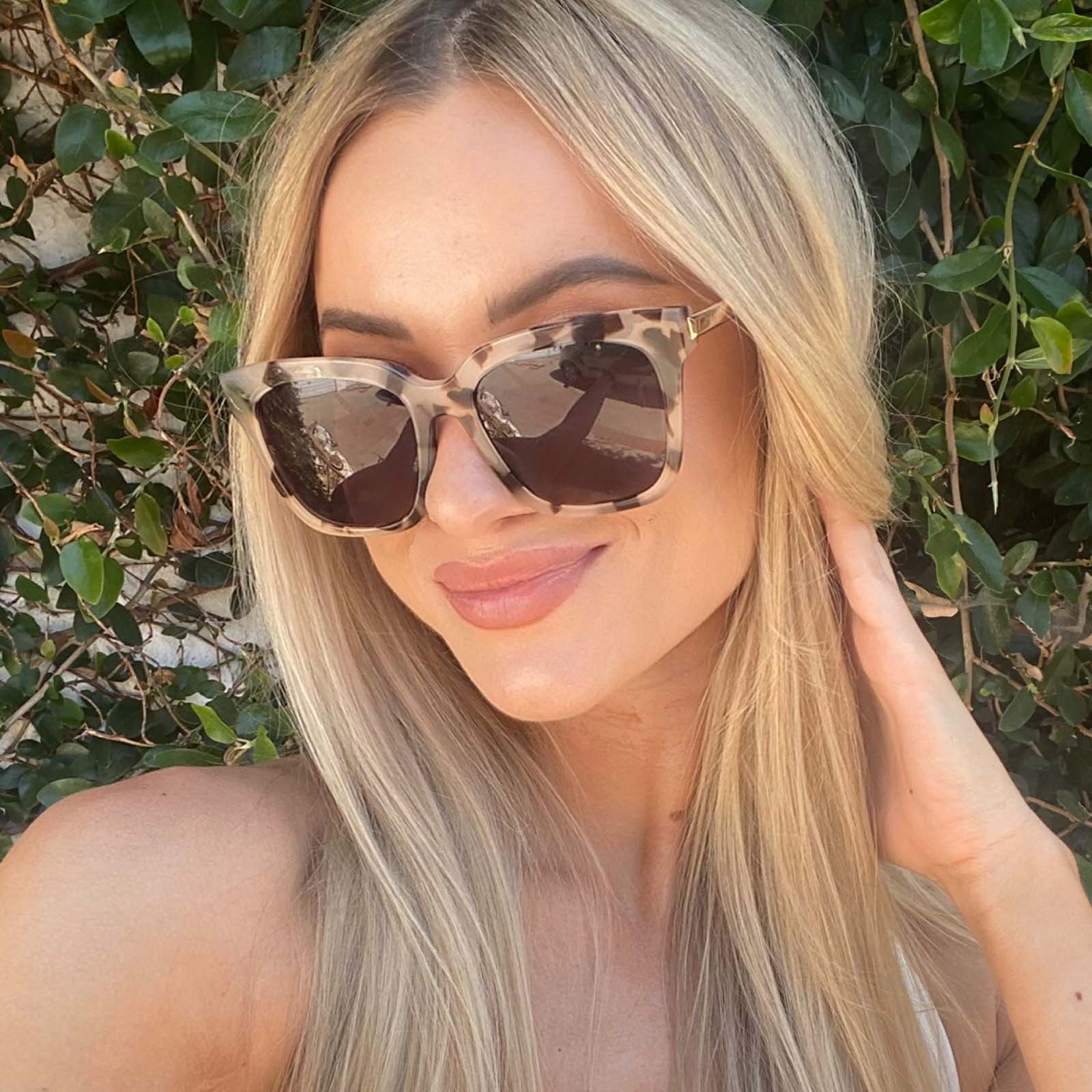 customer content - female with long blonde hairwearing diff eyewear bella square sunglasses with a cream tortoise frame and grey gradient polarized lenses