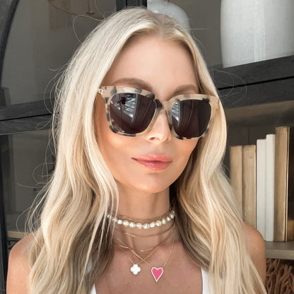 lifestyle - tay bradenburg wearing diff eyewear bella square sunglasses with a cream tortoise frame and grey lenses front view