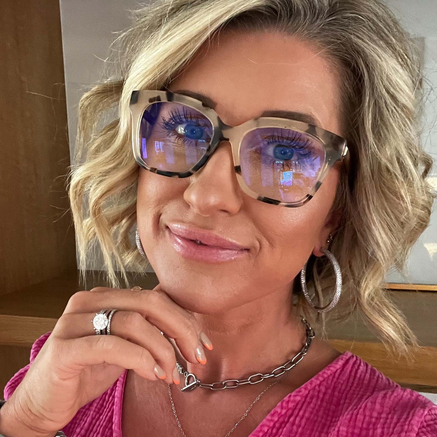 lifestyle - blonde female wearing bella xs square eyeglasses with a cream tortoise frame and blue light technology lenses