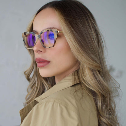 lifestyle - blonde female wearing BELLA XS - CREAM TORTOISE + BLUE LIGHT front