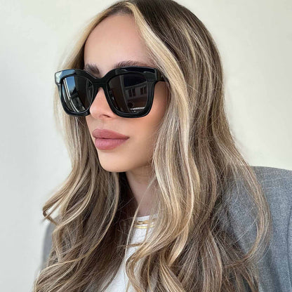 lifestyle - blonde female wearing Carson Black Dark Smoke Polarized sunglasses