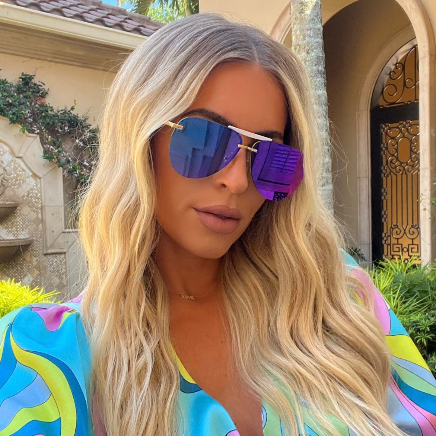 customer content - female wearing diff eyewear tahoe aviator sunglasses with a gold frame and purple mirror lenses