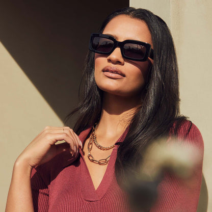 on model - female wearing diff eyewear indy rectangular sunglasses with a black acetate frame and grey polarized lenses front view