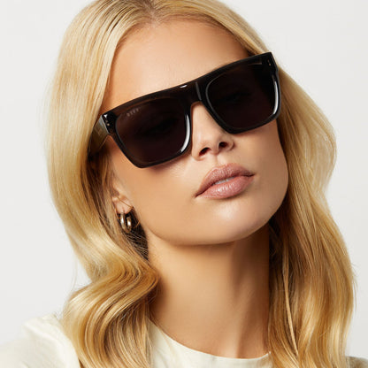 on model - female wearing diff eyewear featuring the easton square sunglasses with a black smoke crystal frame and grey mirror lenses front view