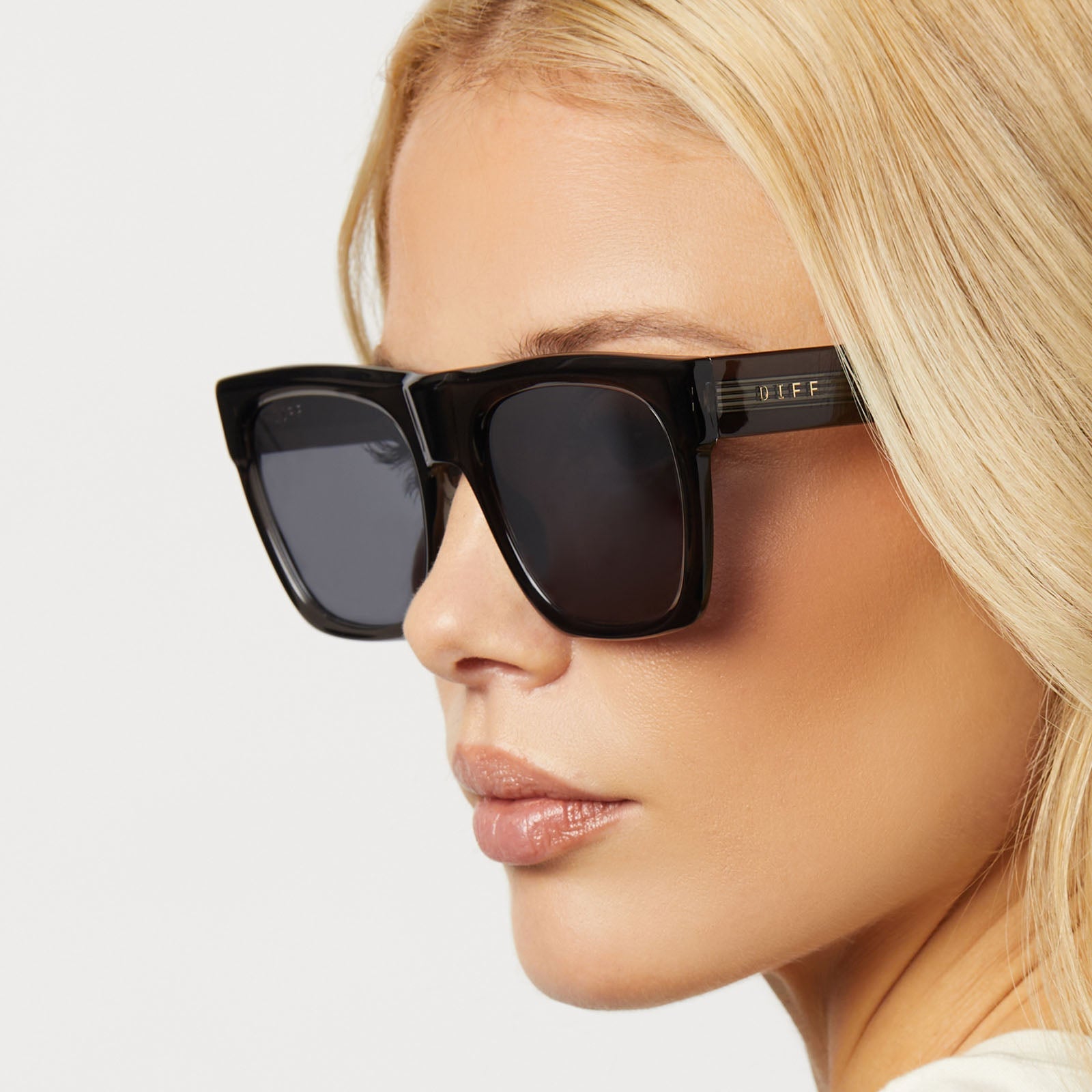 on model - female wearing diff eyewear featuring the easton square sunglasses with a black smoke crystal frame and grey mirror lenses detailed view