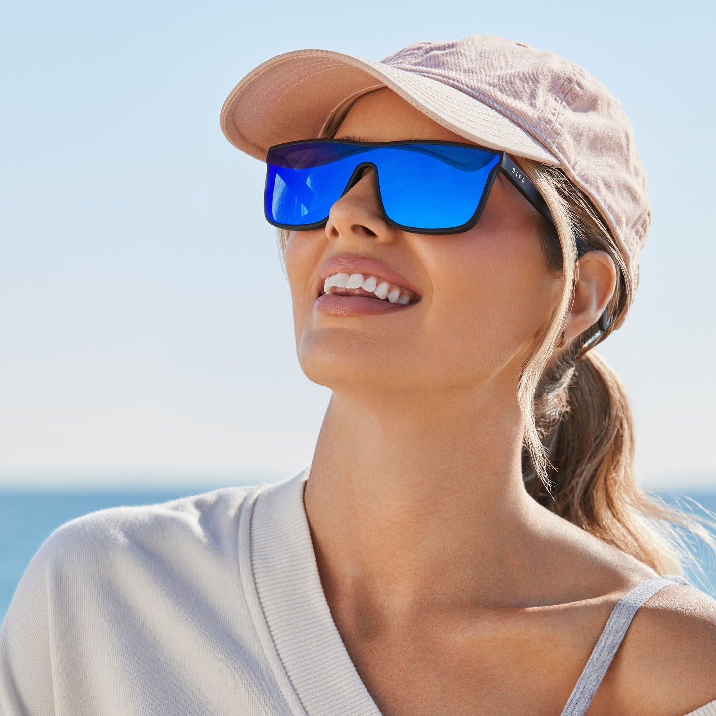 lifestyle - female wearing diff sport flash square sunglasses with a matte black frame and blue mirror polarized lenses