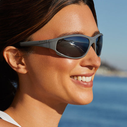 lifestyle - female staring out on the ocean while wearing diff sport lightning sunglasses in grey