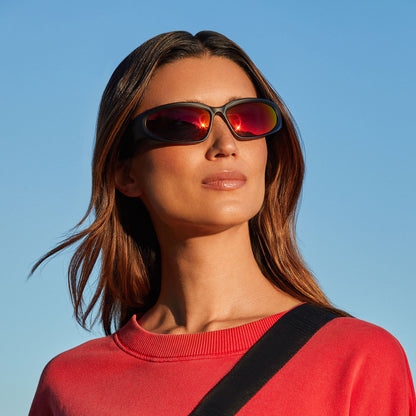 lifestyle - female on a hike wearing diff sport side out sunglasses with a black frame and sunset mirror lenses