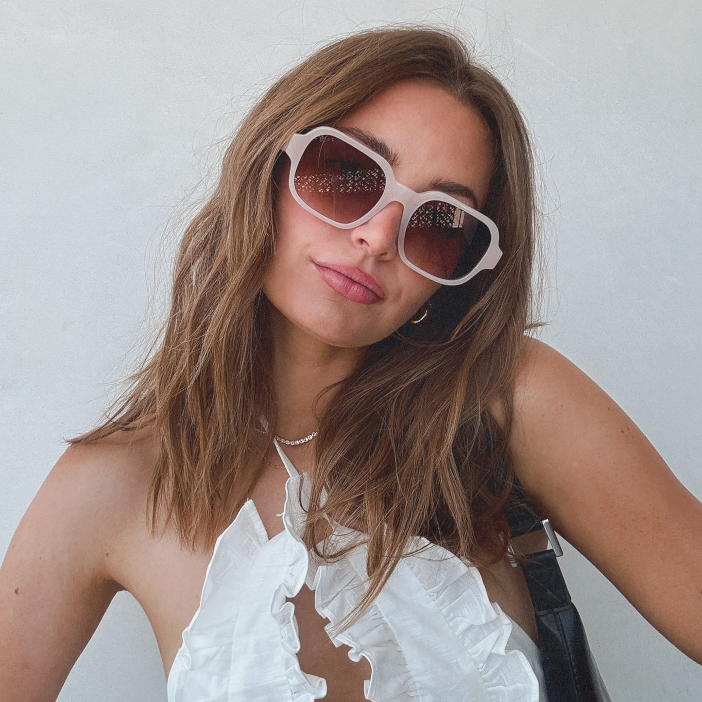 lifestyle - aspyn ovard x diff eyewear female wearing the lola square prescription sunglasses with a milky blush frame front view