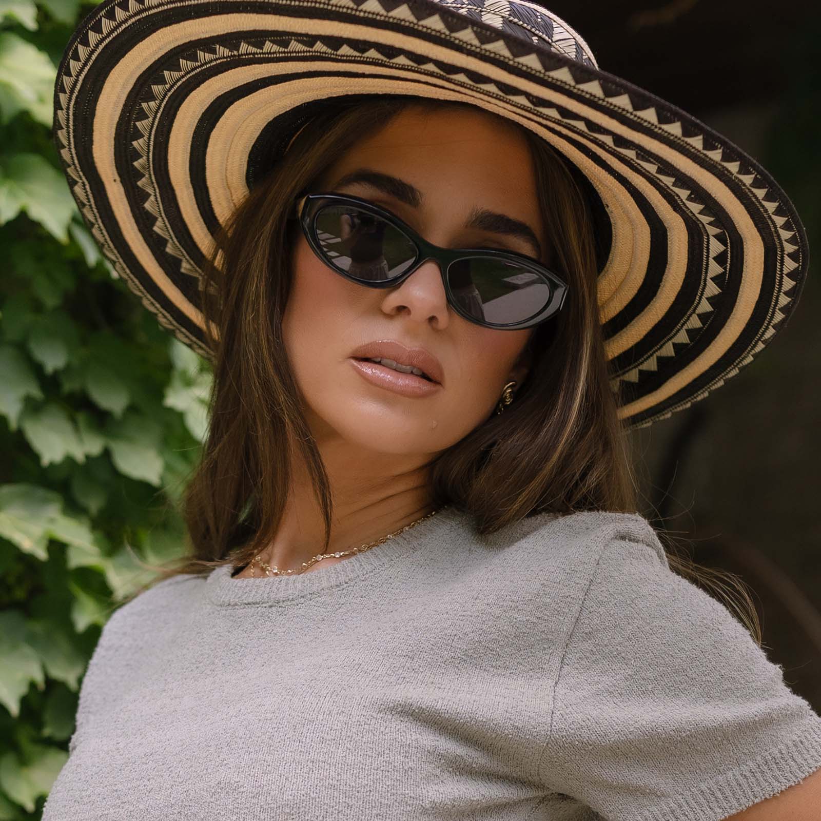 lifestyle - jjd female wearing jessie james decker x diff eyewear featuring the dolce bella oval sunglasses with a black frame and grey lenses front view
