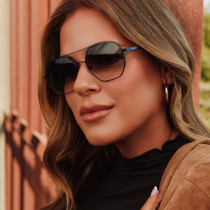 lifestyle - female jojo fletcher wearing diff eyewear joelle navigator sunglasses with a black metal frame and grey gradient lenses angled view