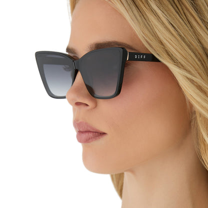 on model - female wearing diff eyewear featuring the alina cat eye sunglasses with a black frame and grey gradient lenses side view