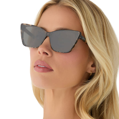 on model - female wearing diff eyewear featuring the alina cat eye sunglasses with a espresso tortoise frame and grey lenses angled view