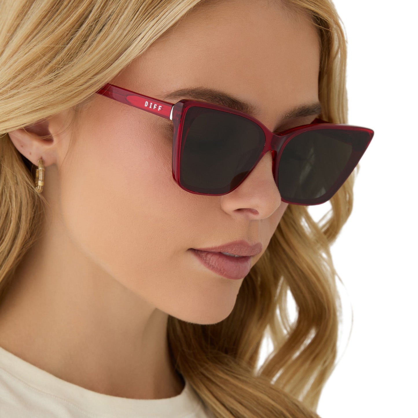 on model - female wearing diff eyewear featuring the alina cat eye sunglasses with a red hot summer frame and grey lenses angled view