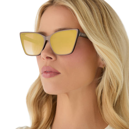 on model - female wearing diff eyewear featuring the alina cat eye sunglasses with a moscow mule brown opalescent frame and brown gradient gold flash lenses angled view