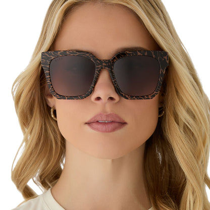 on model - female wearing diff eyewear ariana square sunglasses with a animal print frame and brown gradient lenses front view
