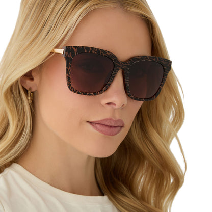 on model - female wearing diff eyewear featuring the bella square sunglasses with a animal print frame and brown gradient lenses angled view