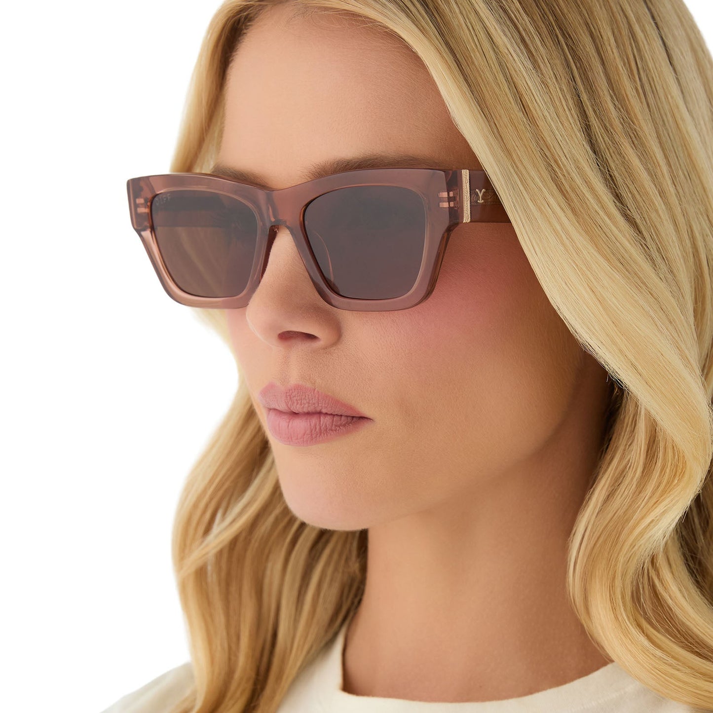 on model - female wearing yellowstone x diff eyewear featuring the beth ii cat eye sunglasses with a cafe ole frame and brown polarized lenses angled view