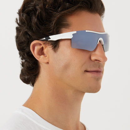 on model - male wearing diff sport blitz shield sunglasses with a matte white frame and grey gradient with silver flash polarized lenses angled view