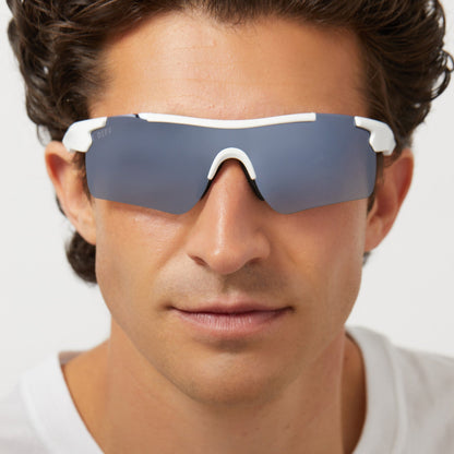 on model - male wearing diff sport blitz shield sunglasses with a matte white frame and grey gradient with silver flash polarized lenses front view