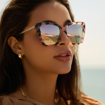 lifestyle - female at the beach wearing diff eyewear becky ii in himalayan tortoise and taupe mirror polarized sunglasses angled view