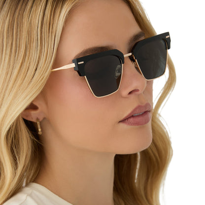 on model - female wearing diff eyewear featuring the capri rectangle sunglasses with a black frame and grey polarized lenses angled view