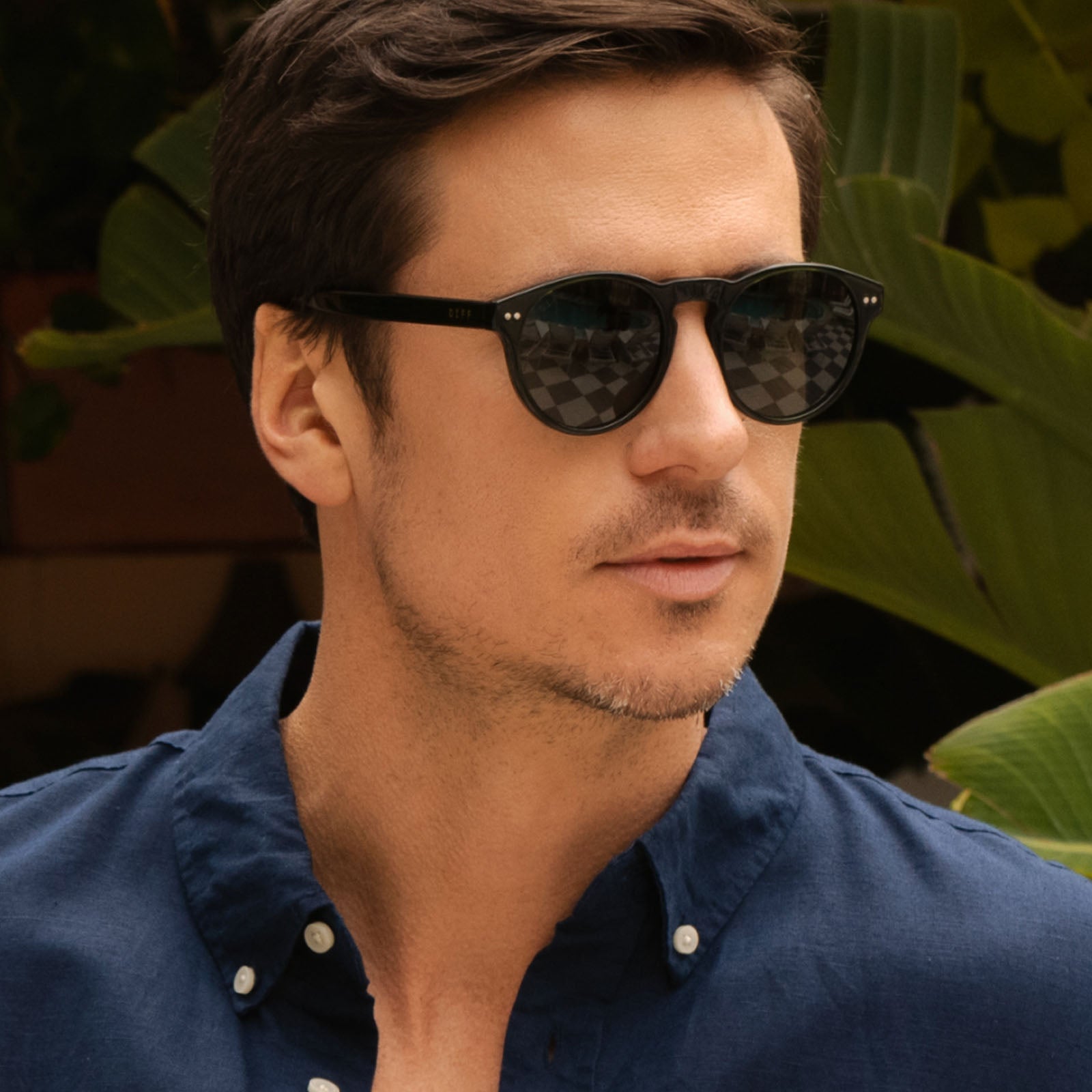 lifestyle - male wearing diff eyewear featuring the cody xl round sunglasses with a dark olive crystal frame and g15 polarized lenses front view