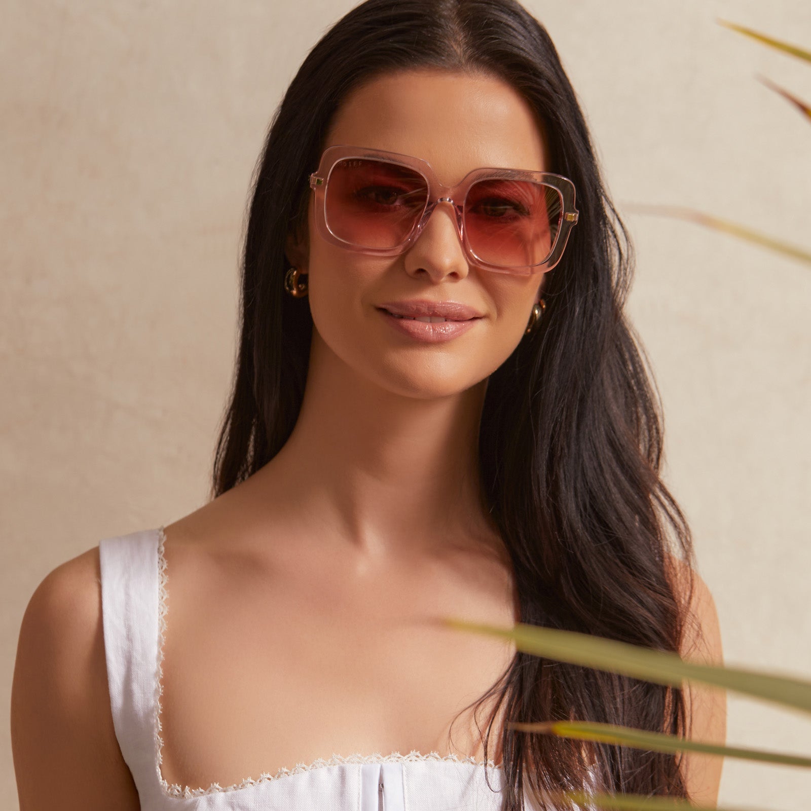 on model - female wearing diff eyewear sandra square sunglasses with a light pink crystal frame and peach dusk gradient lenses front view