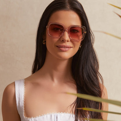 on model - female wearing diff eyewear sandra square sunglasses with a light pink crystal frame and peach dusk gradient lenses front view