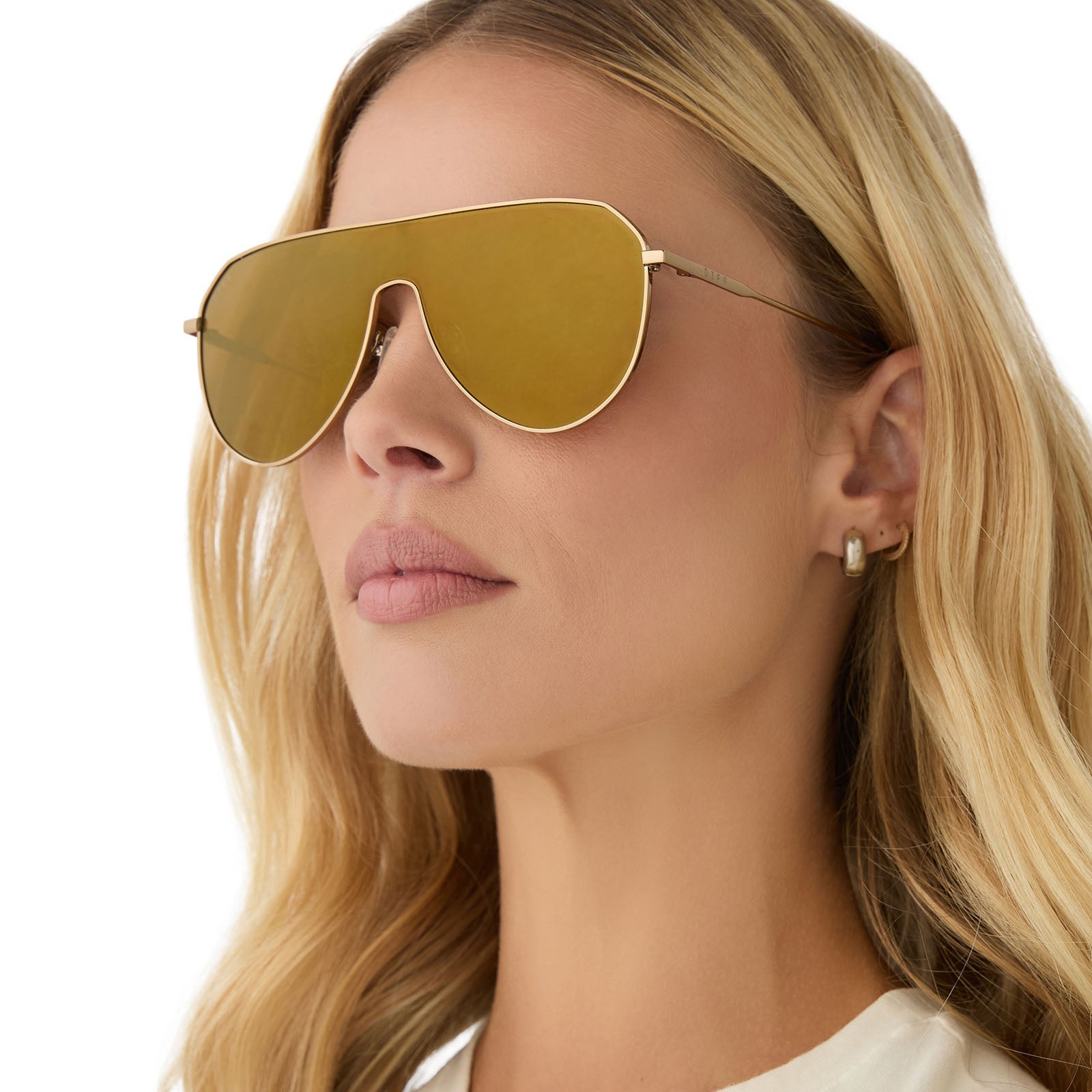 on model - female wearing diff eyewear featuring the dash shield shield sunglasses with a copper metal frame and brown gold flash lenses angled view