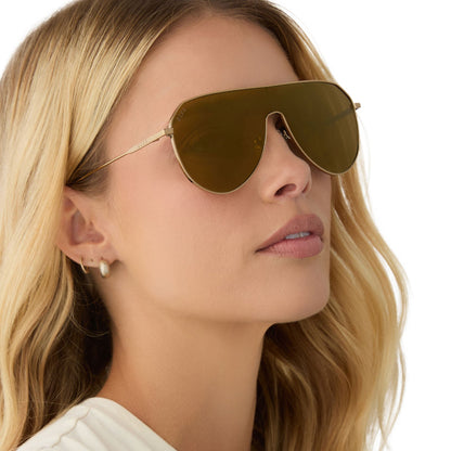 on model - female wearing diff eyewear featuring the dash shield shield sunglasses with a copper metal frame and brown gold flash lenses side view