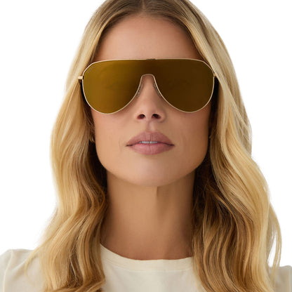 on model - female wearing diff eyewear featuring the dash shield shield sunglasses with a copper metal frame and brown gold flash lenses front view