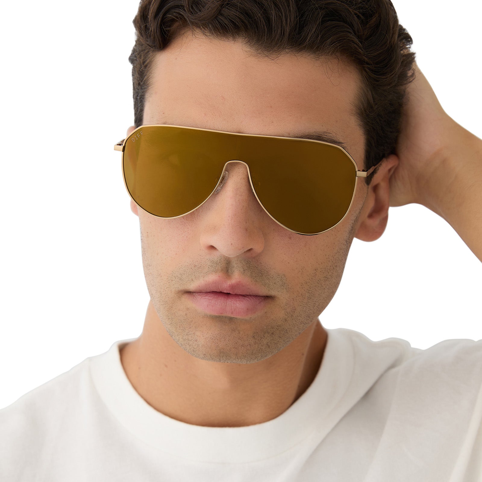 on model - male wearing diff eyewear featuring the dash shield shield sunglasses with a copper metal frame and brown gold flash lenses front view