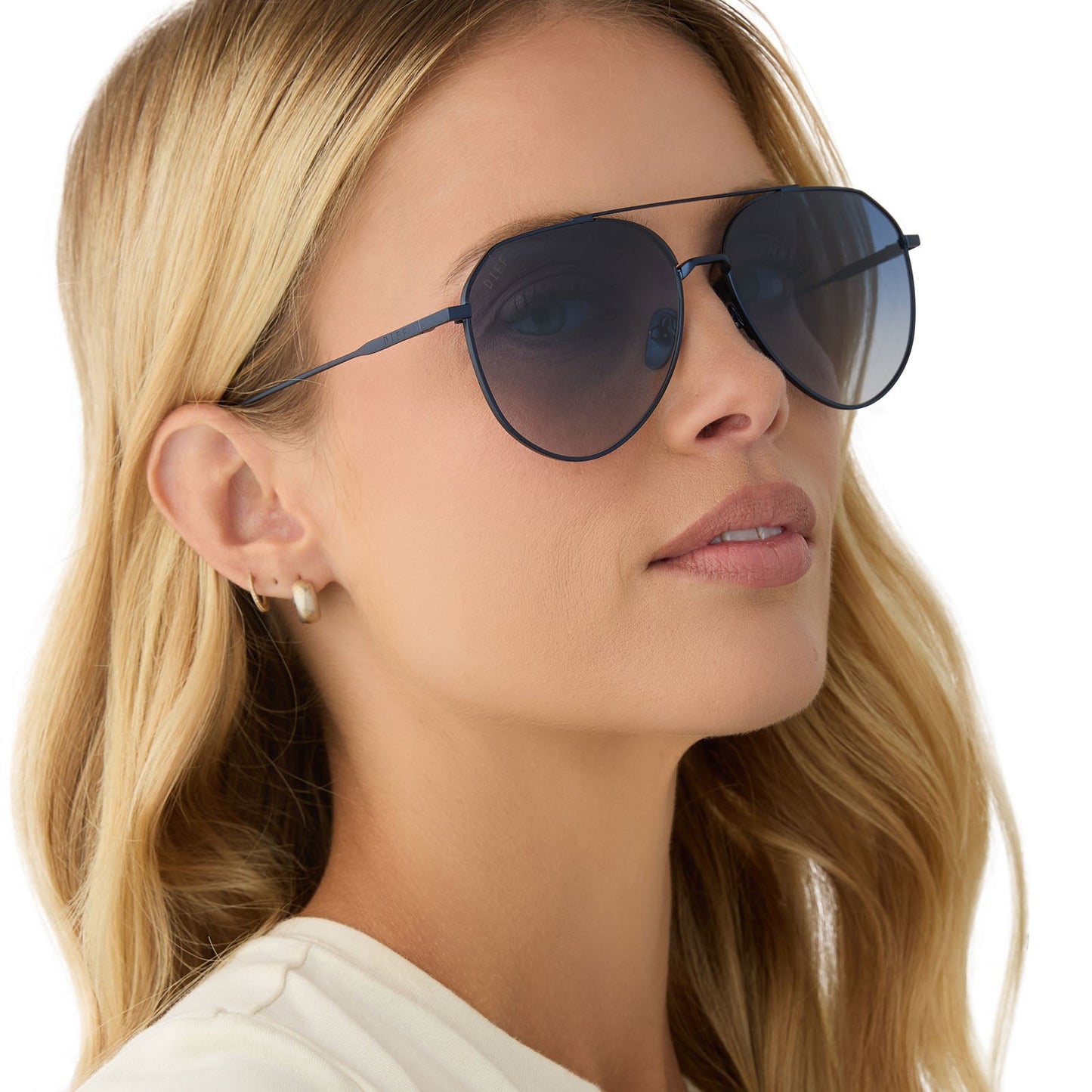 on model - female wearing diff eyewear featuring the dash aviator sunglasses with a deep navy metal frame and aegean blue flash lenses side view