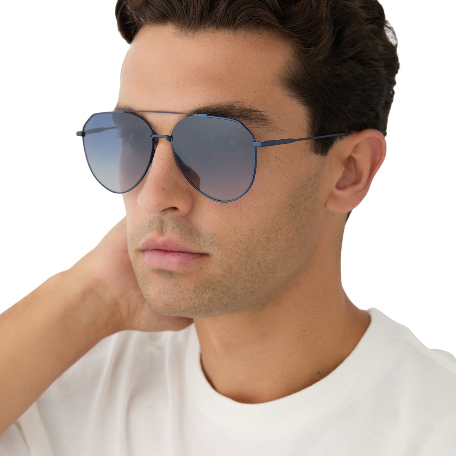 on model - male wearing diff eyewear featuring the dash aviator sunglasses with a deep navy metal frame and aegean blue flash lenses angled view