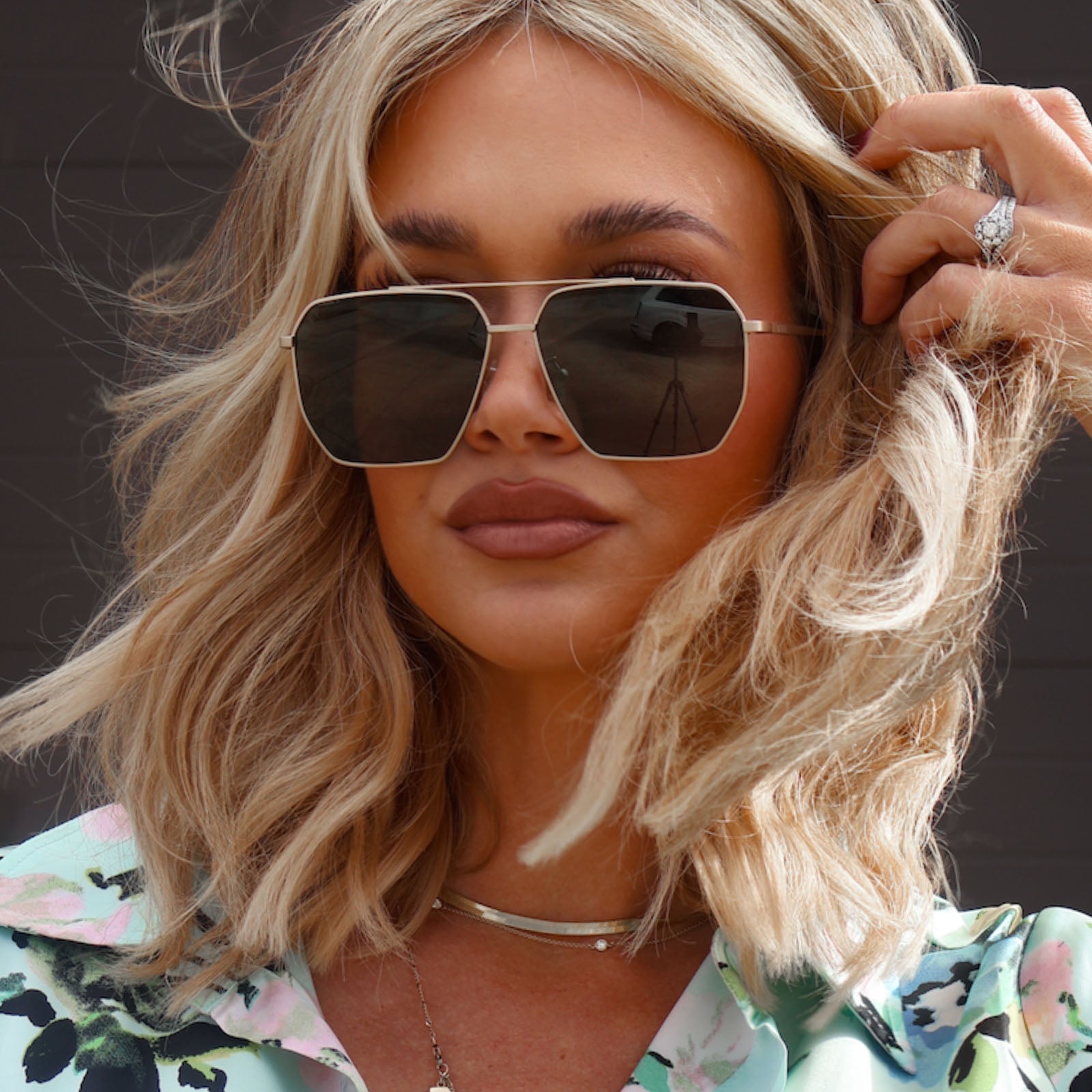 lifestyle - minimally_her wearing diff eyewear featuring the berkely navigator prescription sunglasses with a brushed gold frame front view