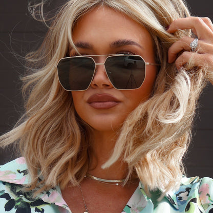 lifestyle - minimally_her wearing diff eyewear featuring the berkely navigator prescription sunglasses with a brushed gold frame front view