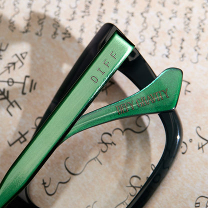 lifestyle - wicked x diff eyewear featuring the elphaba emerald square prescription glasses with a black green gradient frame detailed view of temple and temple tip with quote "Defy gravity"