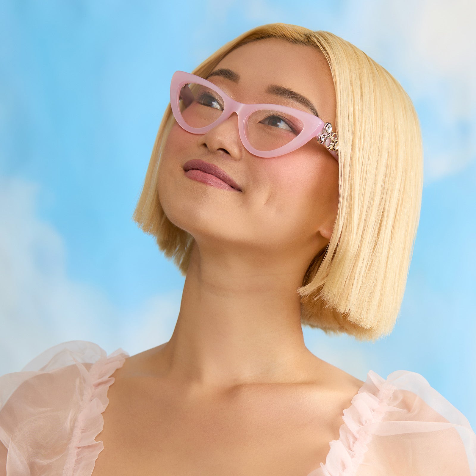on model - female wearing wicked x diff eyewear featuring the glinda upland for good cat eye prescription glasses with a pink frame angled view