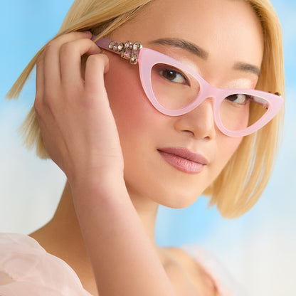 on model - female wearing wicked x diff eyewear featuring the glinda upland for good cat eye prescription glasses with a pink frame angled view