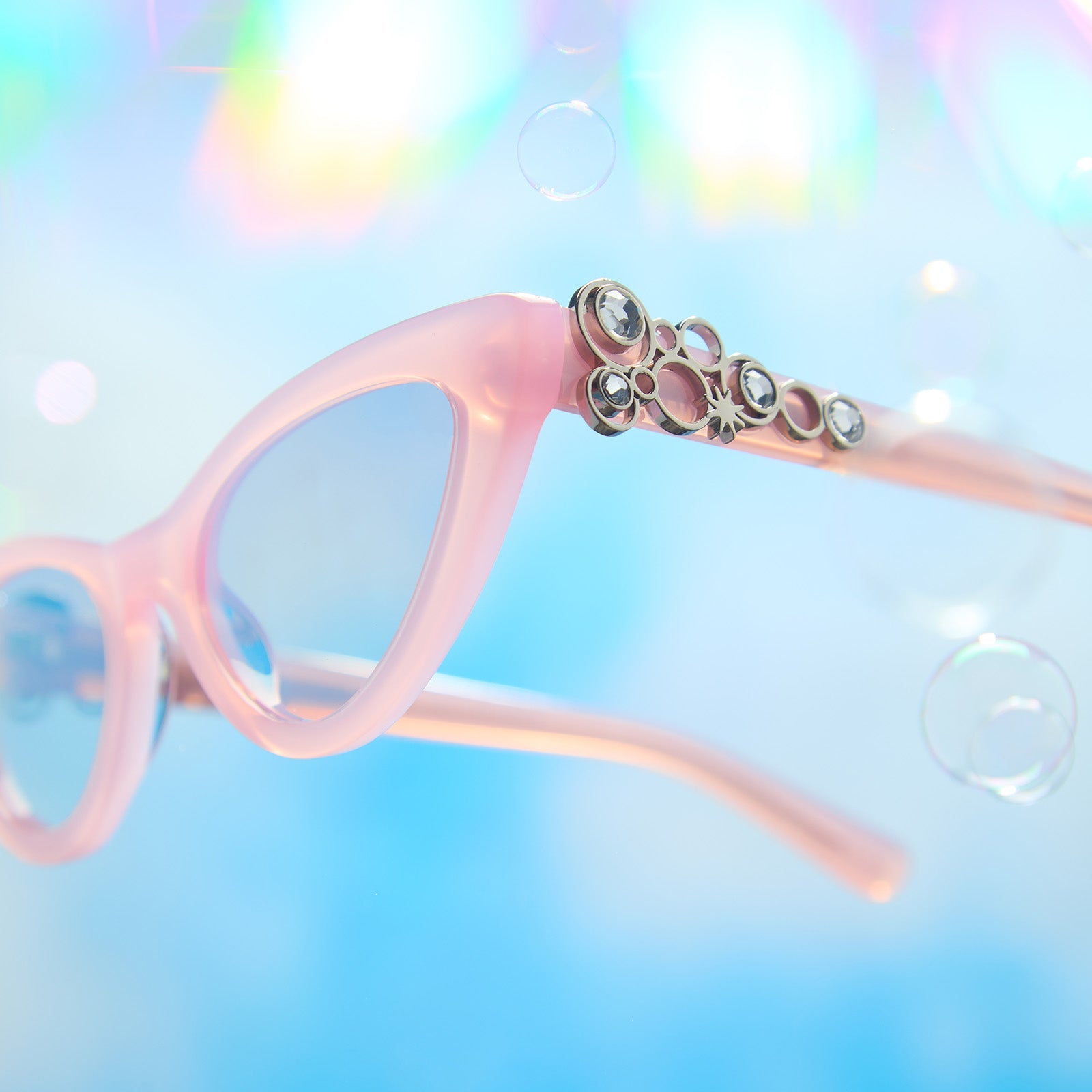 lifestyle - wicked x diff eyewear featuring the glinda upland for good cat eye prescription glasses with a pink frame detailed view of temple