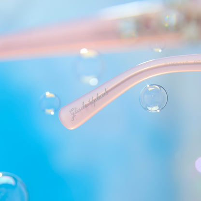 lifestyle - wicked x diff eyewear featuring the glinda upland for good cat eye prescription glasses with a pink frame detailed view of temple tip with Glinda Upland name