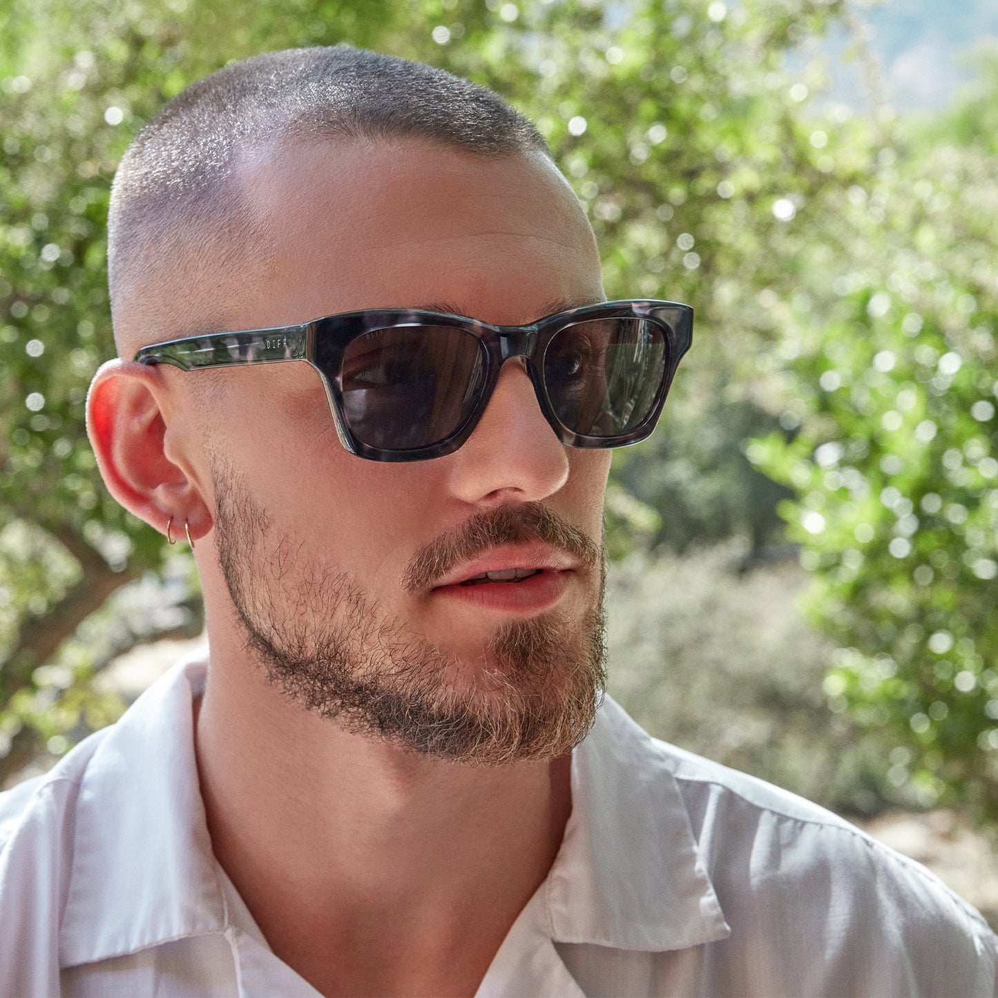 Male model outside wearing the dean black marble and grey polarized