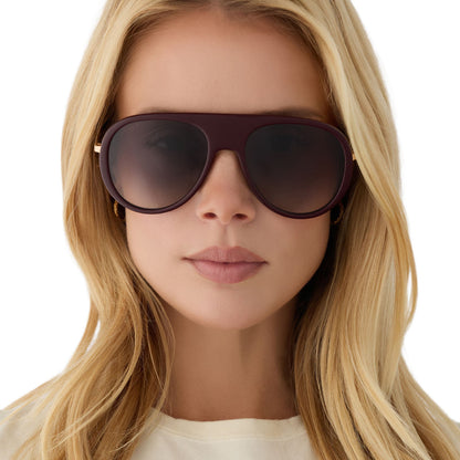 on model - blonde female wearing diff eyewear cleo oversized aviator sunglasses with a dark cherry lacquer red frame, gold temples and grey gradient polarized lenses front view